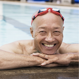 Active senior man smiling confidently with dental implants at All on Four Dental Implants