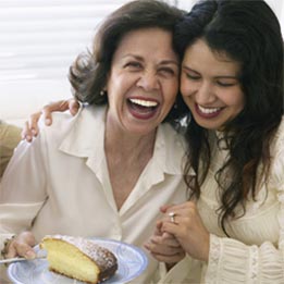 Woman enjoying food with natural-looking dental implants at All on Four Dental Implants